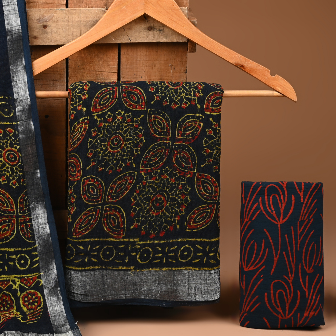 Patterned fabric on a wooden hanger against a brown background