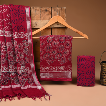 Red patterned fabric on a wooden hanger against a brown background