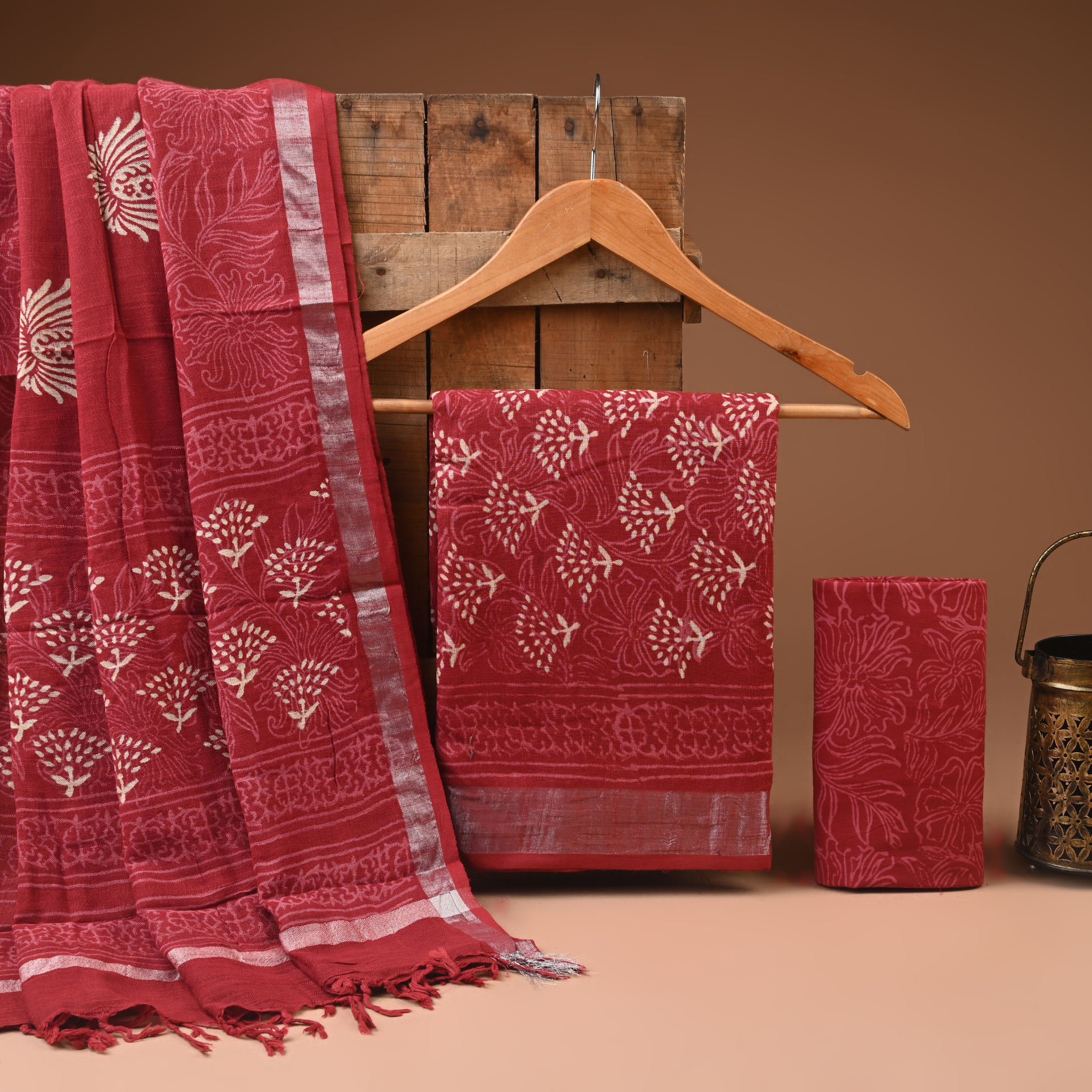 Red patterned fabric on a wooden hanger against a brown background
